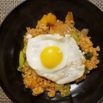 A plate of kimchi brown rice stir fry with an egg