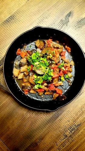 Sauteed eggplant dish with garlic diced tomatoes and parsley