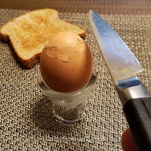 Cut the egg top with a small sharp knife