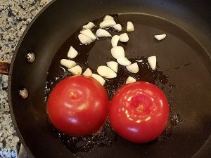 Fry the tomatoes on one side with the garlic