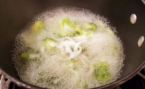 Add the udon noodles to the broccoli and water