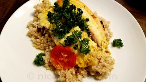 Baked tilapia with coconut milk, spices, served with brown rice