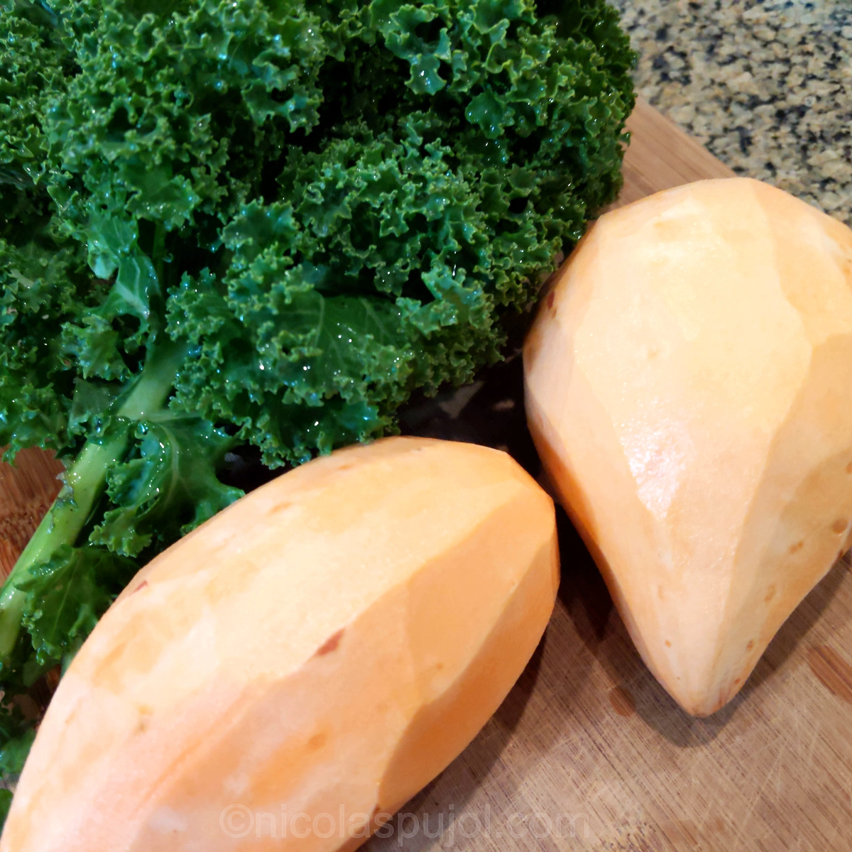 Peeled sweet potatoes and kale for salad preparation