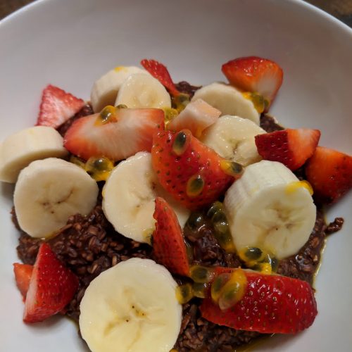 Chocolate oatmeal topped with fruits