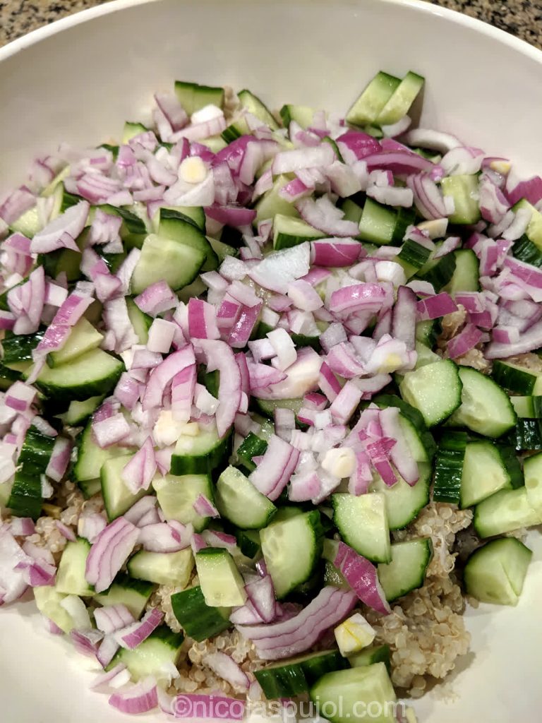 Cooked quinoa, onions, and cucumber for no-oil tabouli salad