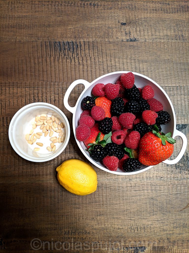 Fresh berries pine nuts and lemon ingredients for fruit salad