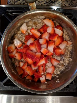 Mix in strawberries with chia seeds raisins and oats