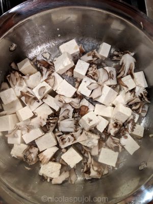 Searing the tofu and maitake mushroom