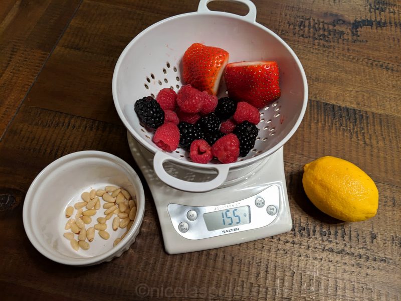 Weighing the mixed berries and nuts for caloric content