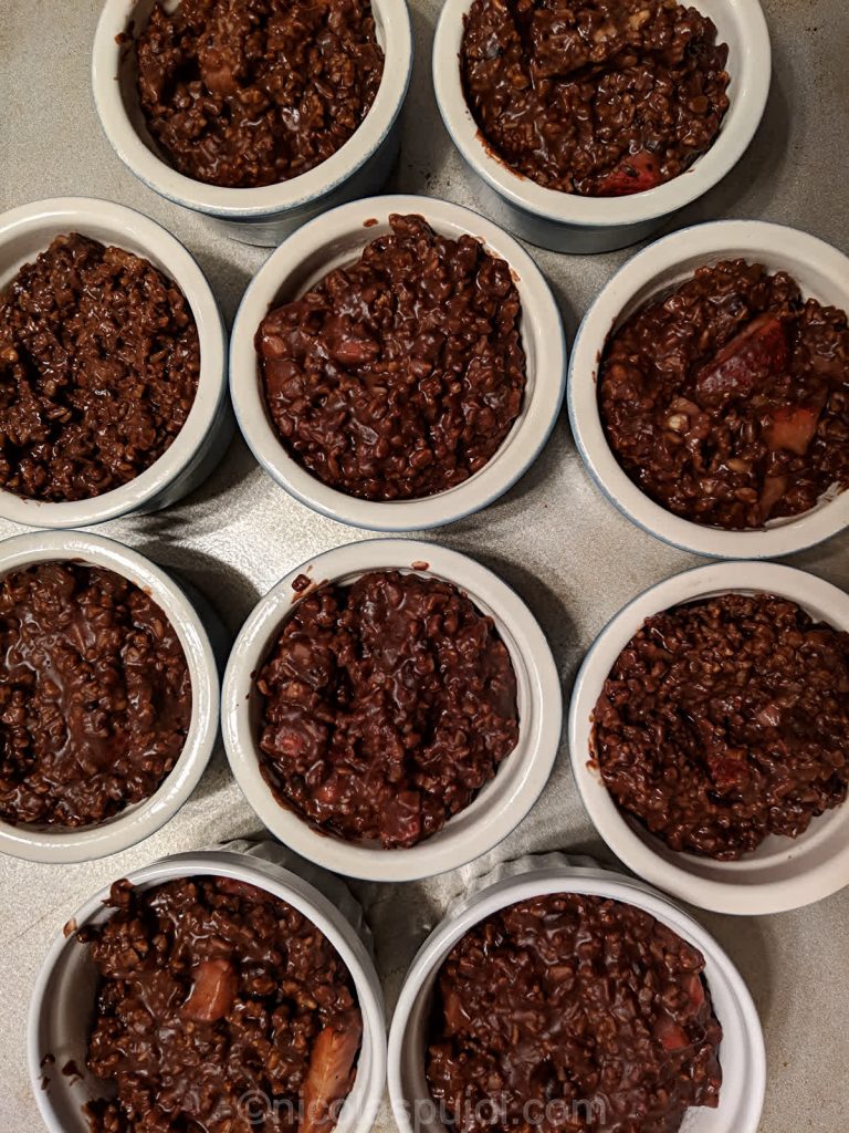 Oatmeal cakes with cocoa powder and berries before baking