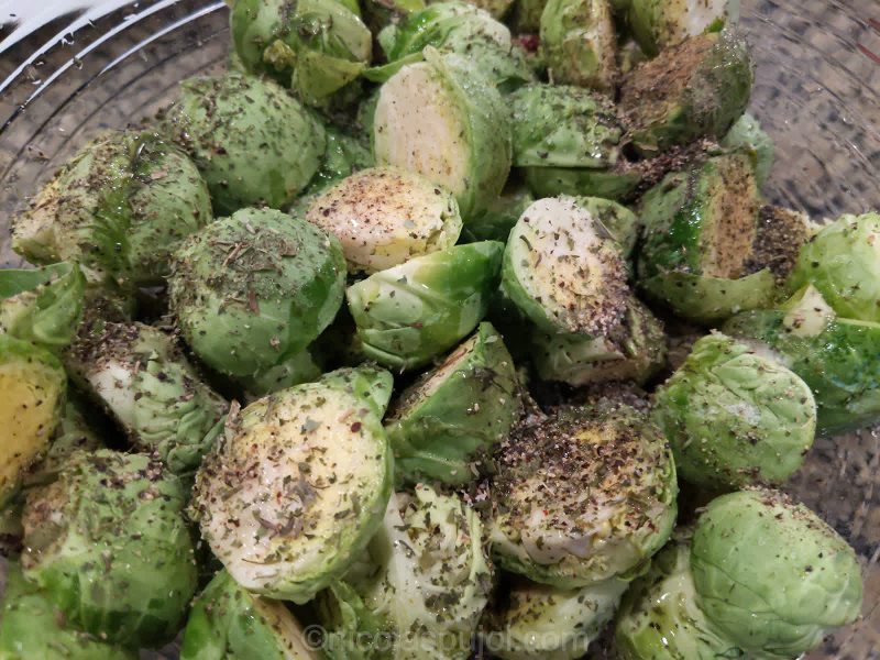 Add herbs and pepper and rub sprouts with hands