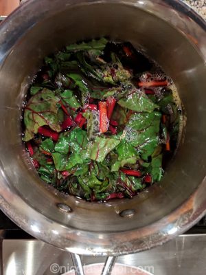 Boil beet greens for a few minutes