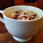 Vegan cappuccino coffee with unsweetened cocoa powder