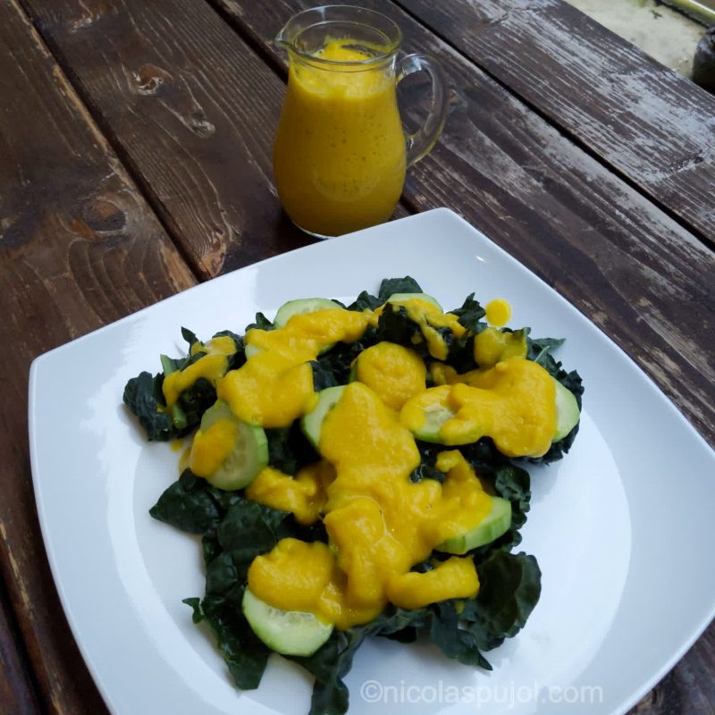 Kale cucumber salad topped with golden beet dressing