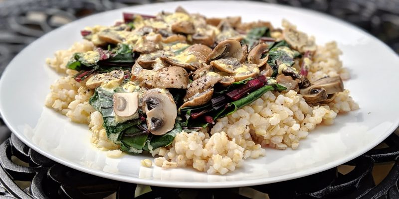 Rice with mushrooms, beet greens and lemon sauce