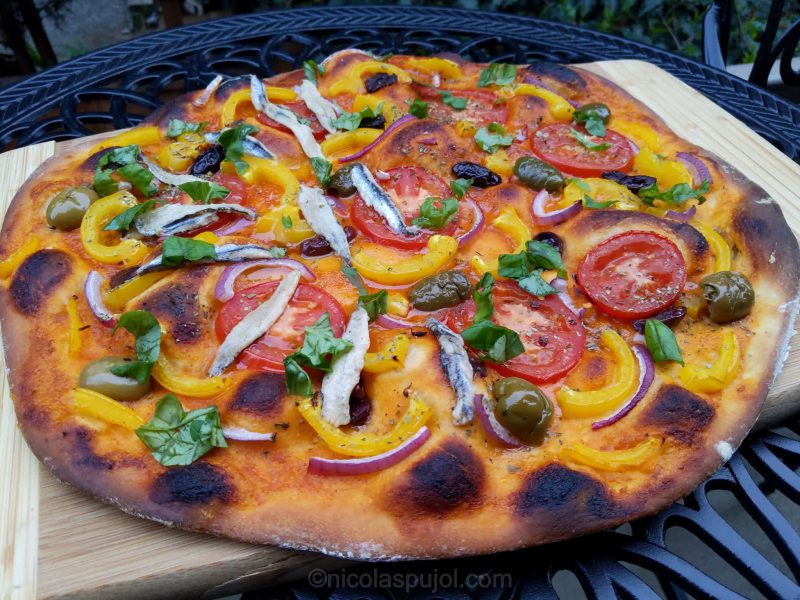 Spanish brava sauce pizza with vegetables and side of anchovies