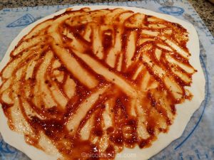 Pizza dough with BBQ sauce