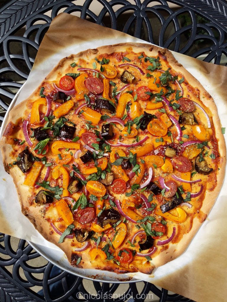 Plant-based pizza with barbecue sauce bell peppers eggplants and tomatoes